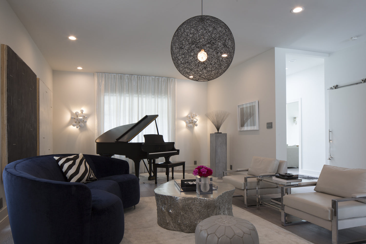 living room with grand piano and orb lighting fixture