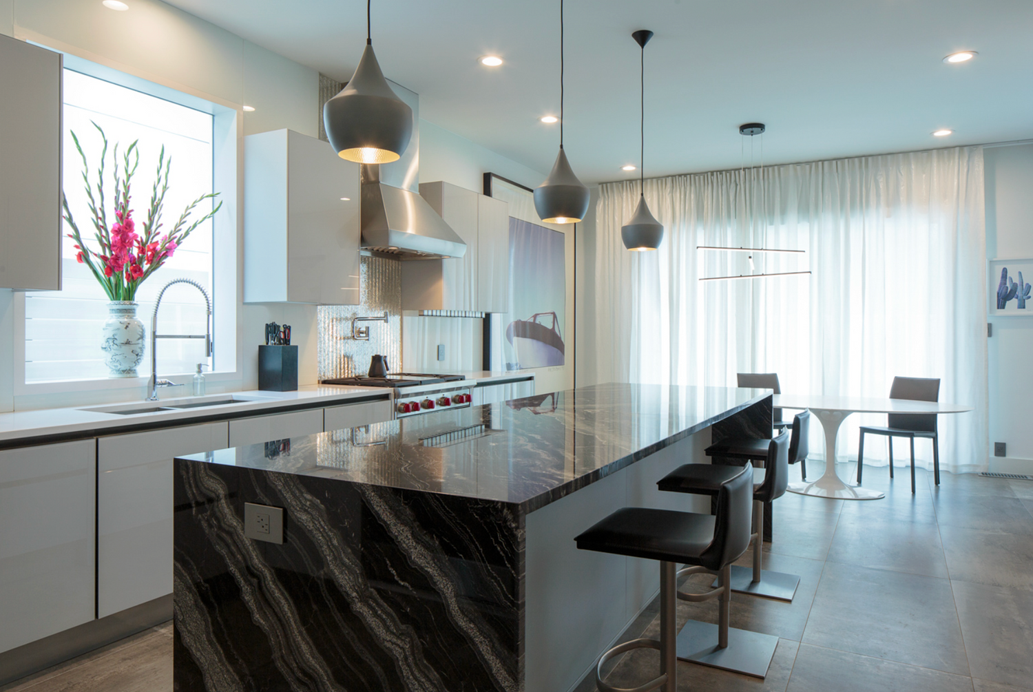 Modern kitchen with marble island and pendant lights
