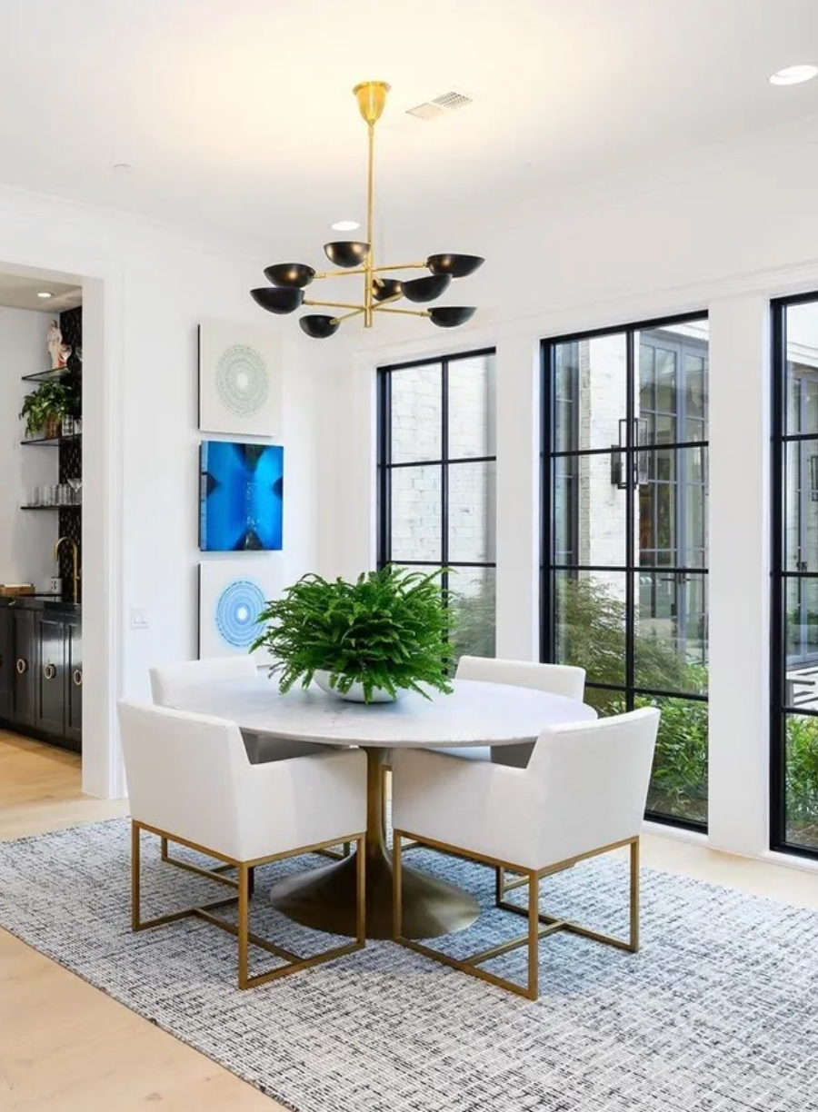 cozy dining nook with chandelier and wall art