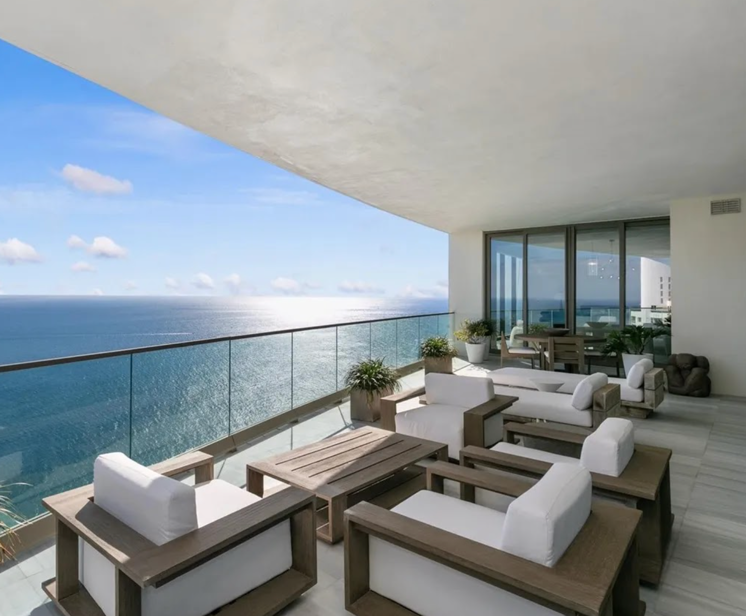 Modern outdoor furniture set on a balcony with ocean view