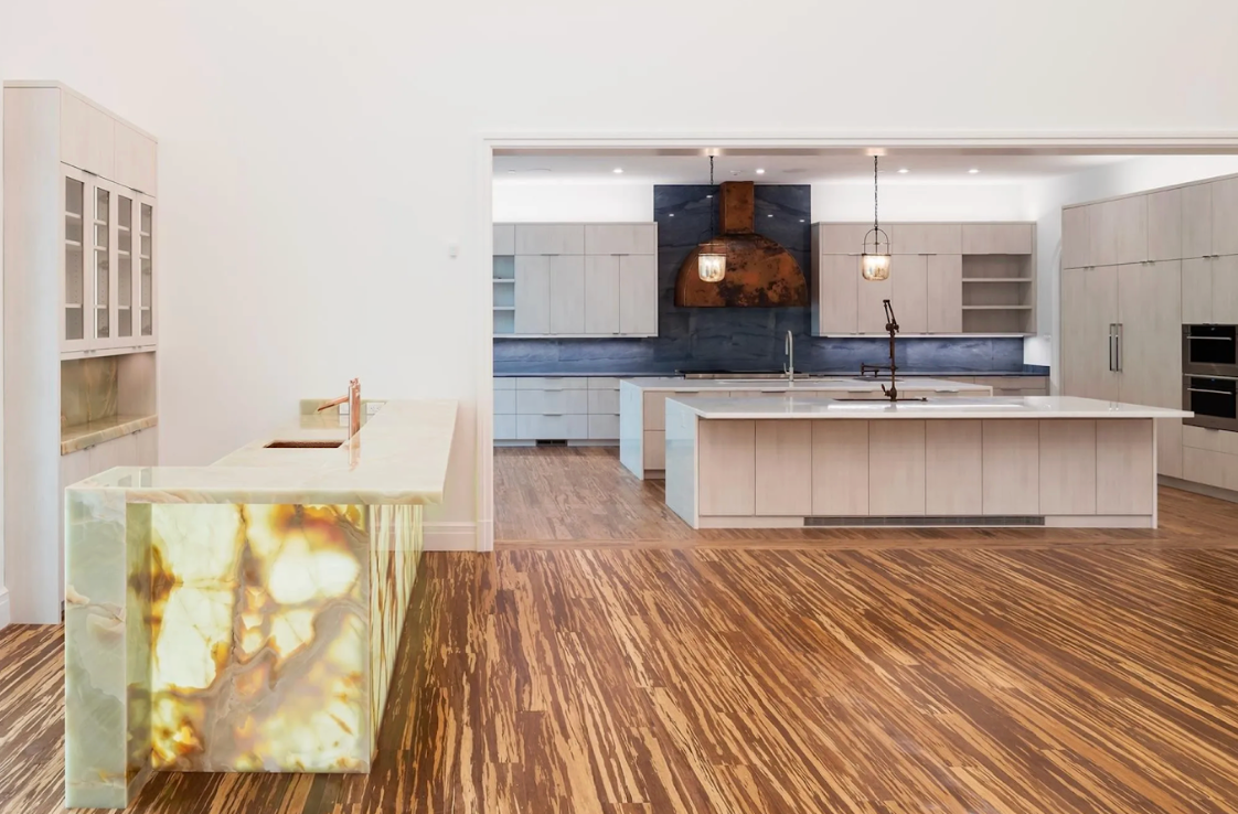 Modern kitchen with wooden flooring and white cabinetry
