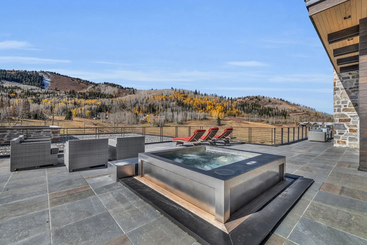 Outdoor hot tub on a patio with mountain view