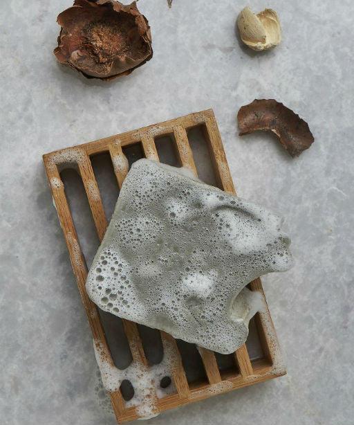 Wooden tray with soap sponge. 