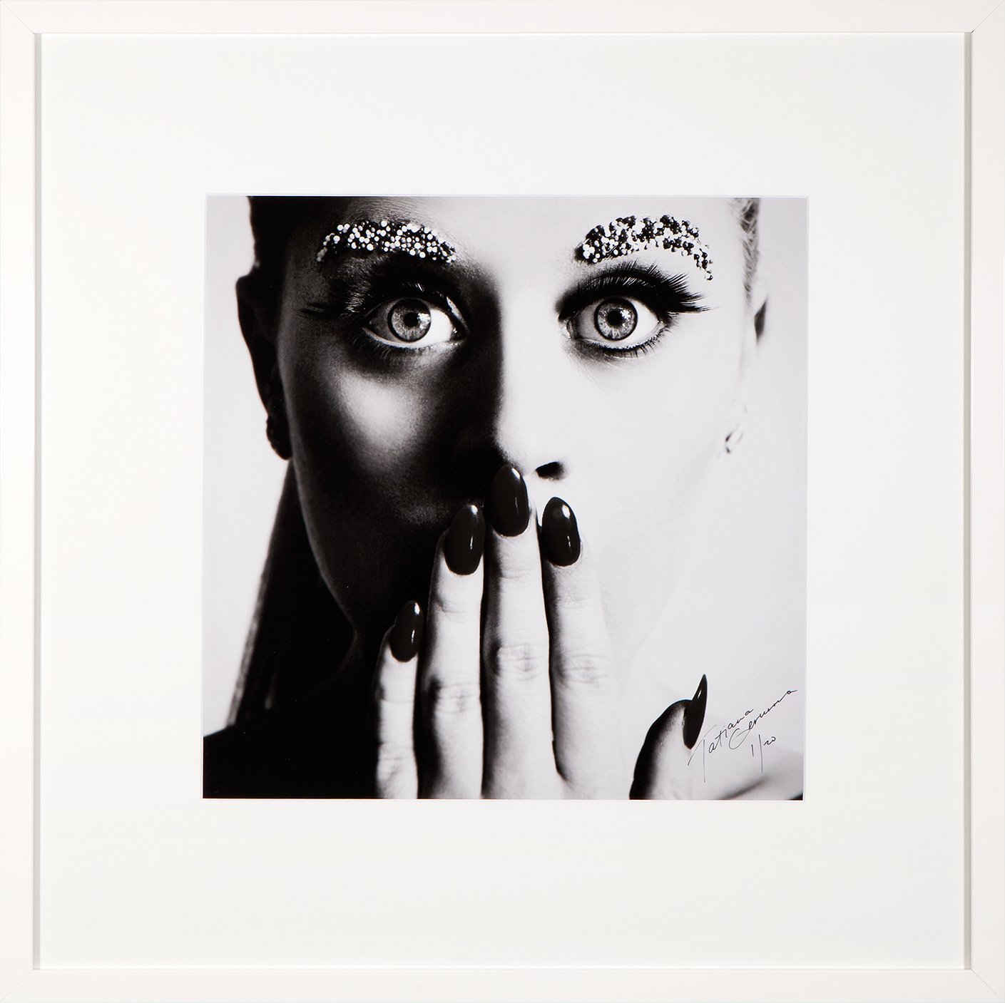 woman covering her mouth with editorial makeup