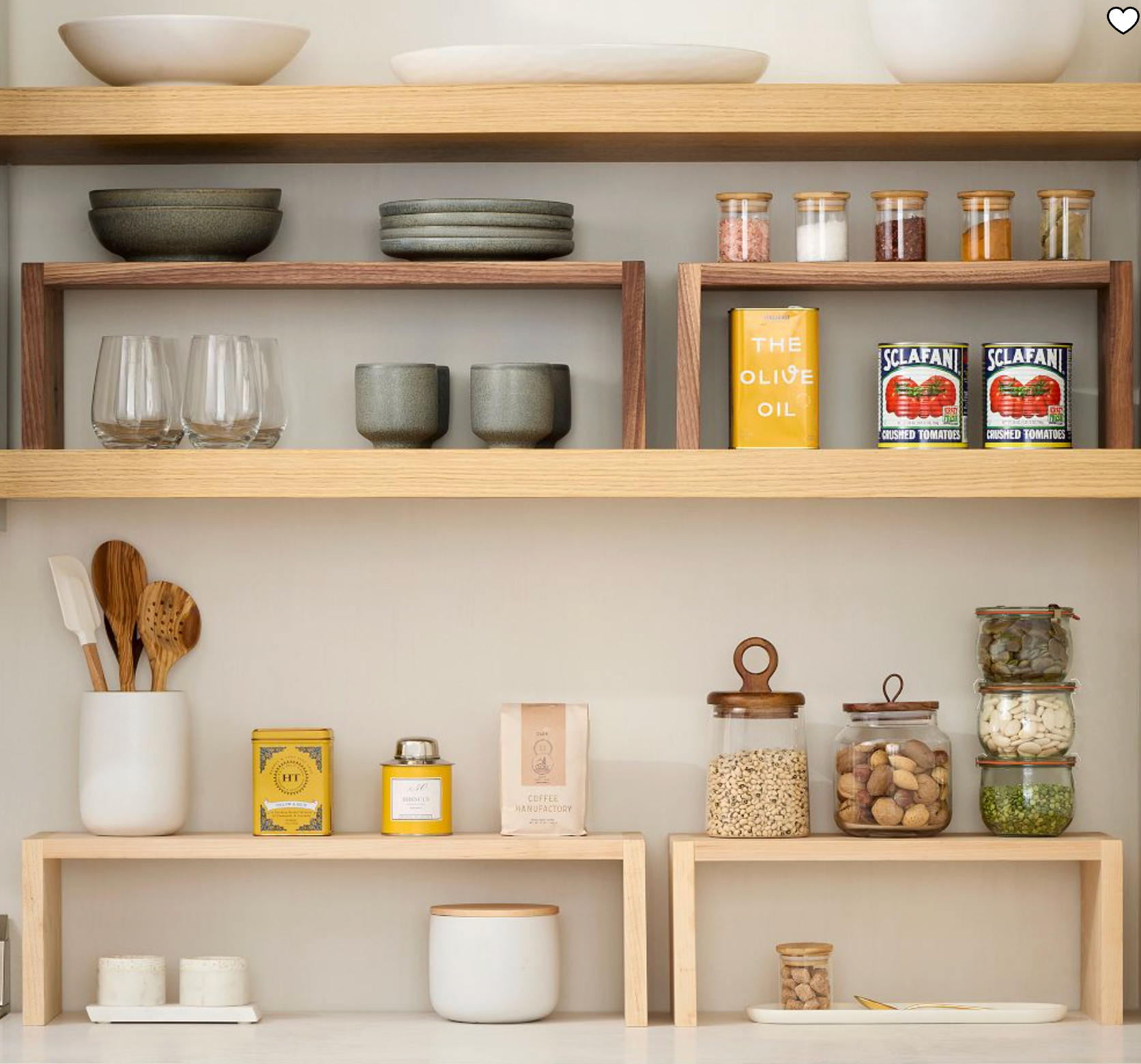 a pantry with shelves and several glasses, plates and food storage containers