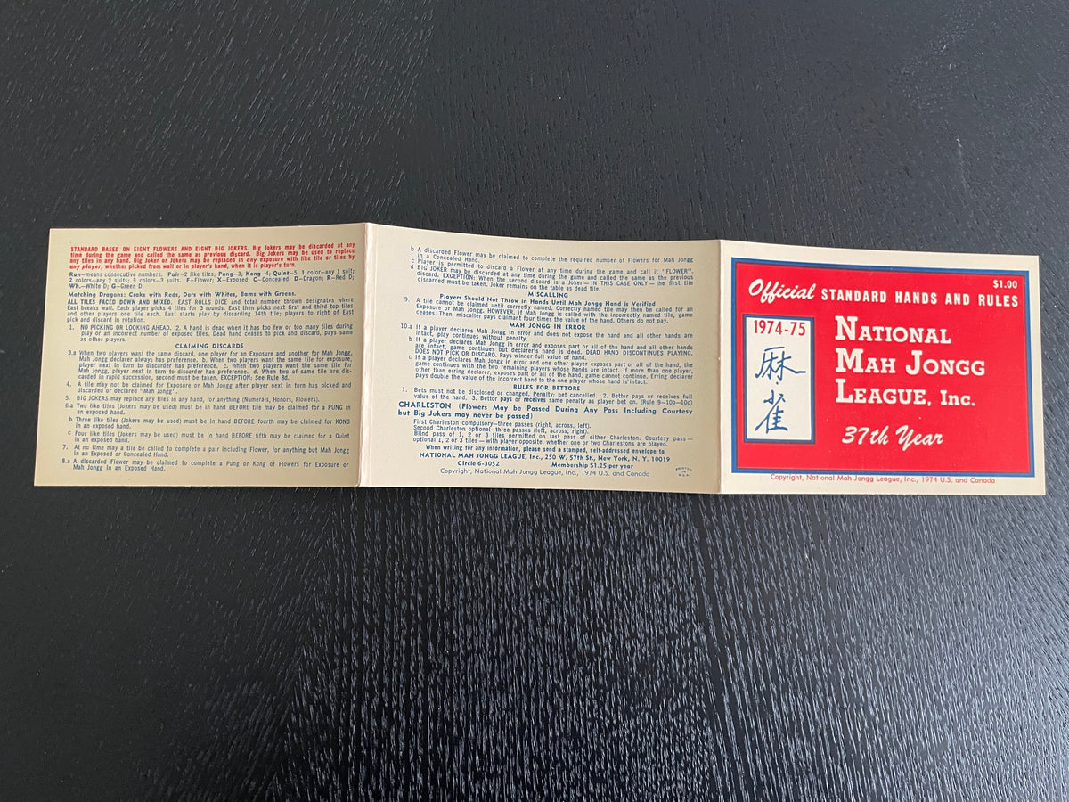 A vintage 1974 National League baseball card set featuring Mickey Mantle, displayed on a dark textured background. The set includes a red-bordered left card, a beige back card with blue text, and a matching beige back card with red text.