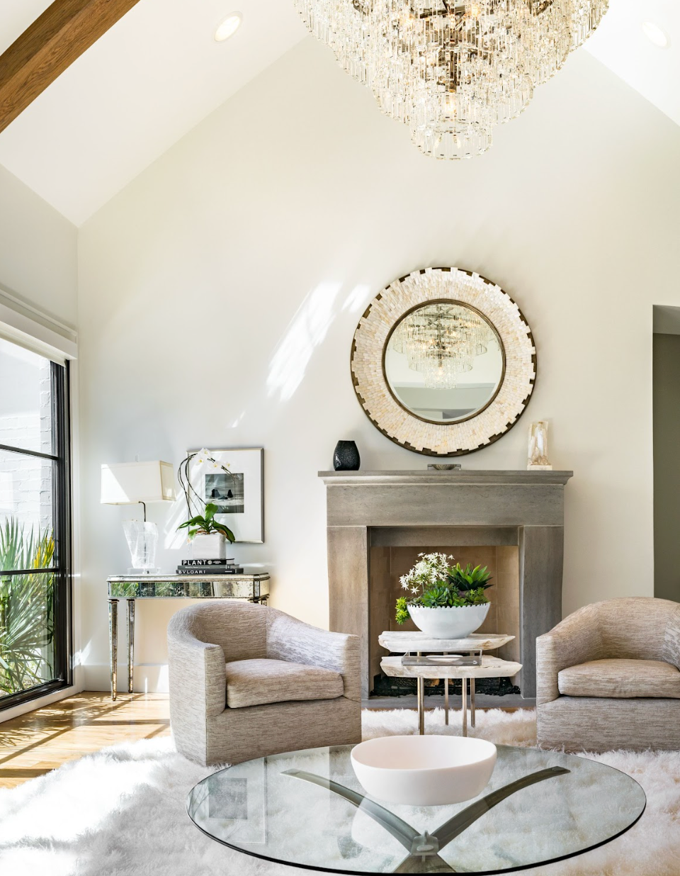 White living room with fireplace, mirror and seating