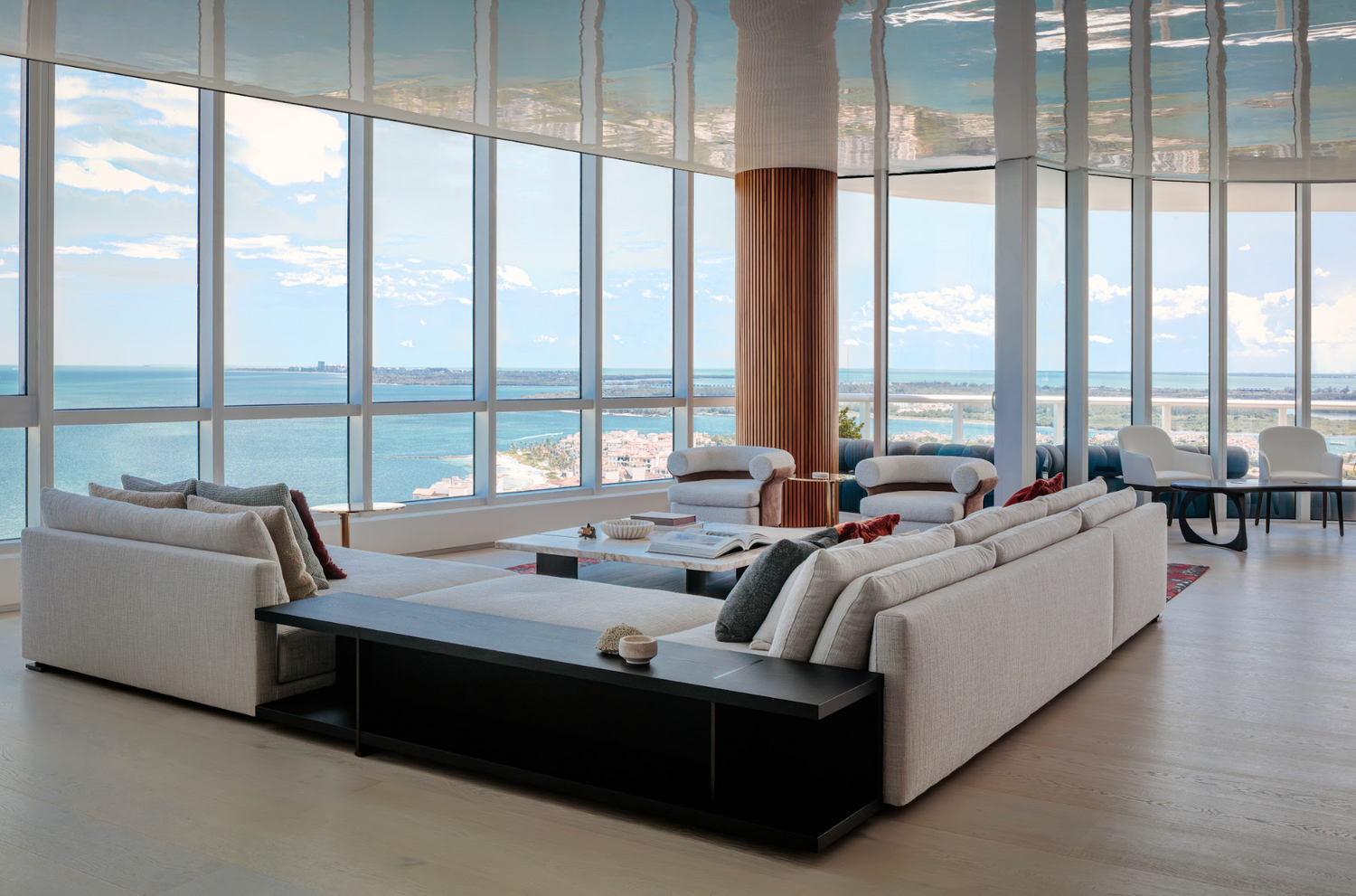 Modern living room with large windows overlooking a scenic view.