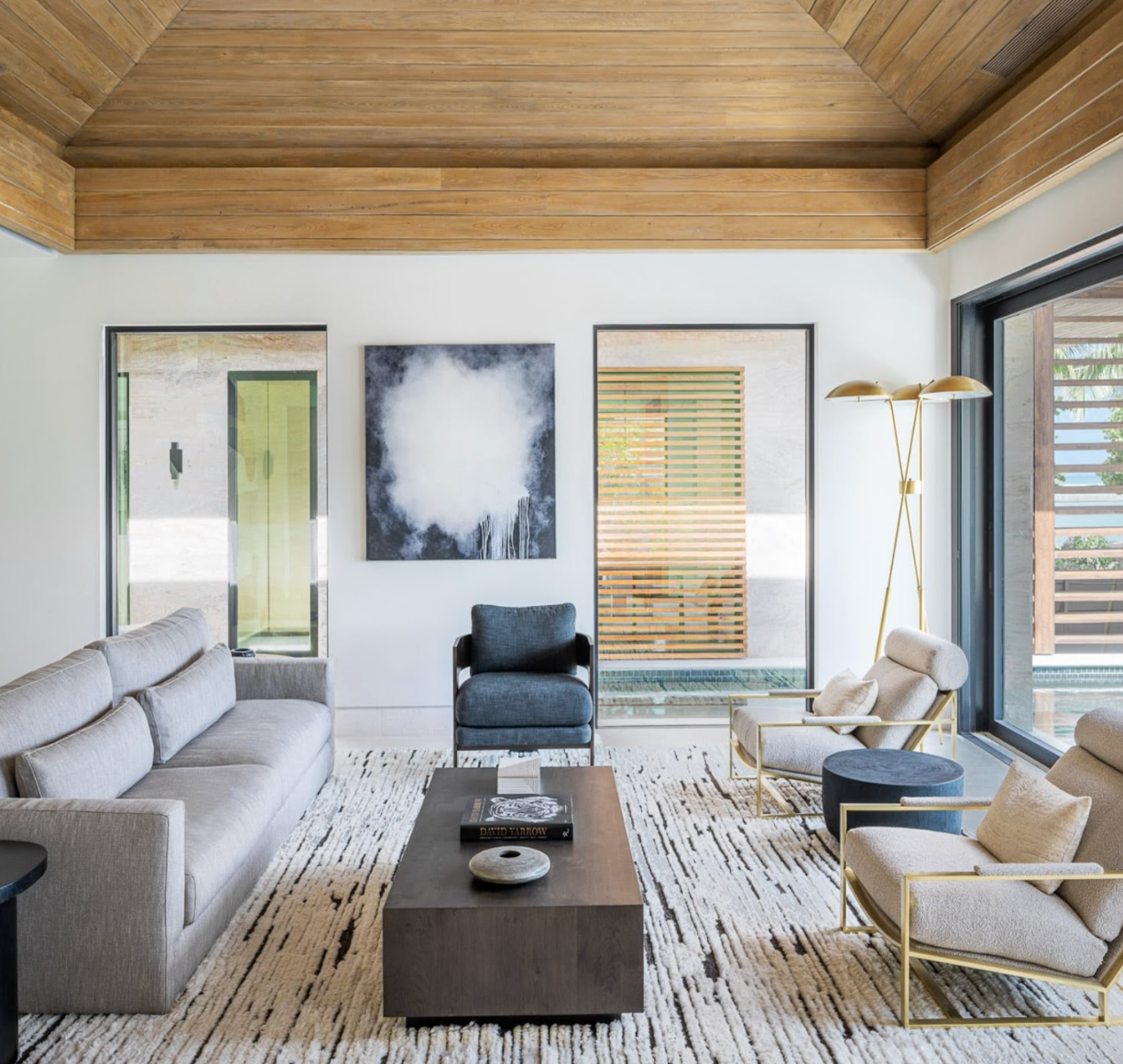 view of living room with grey sofa, artwork and a rug