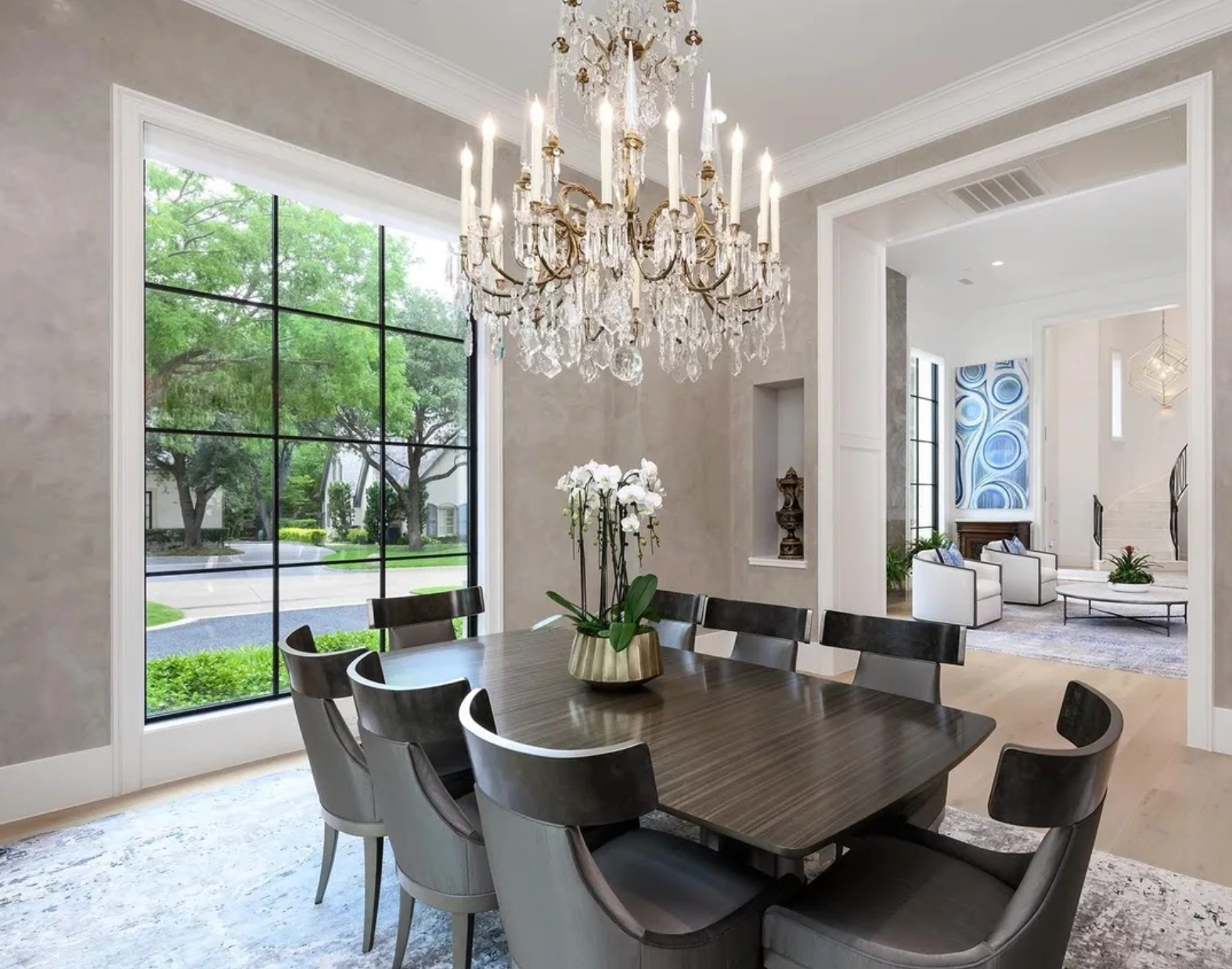 elegant dinning room with crystal chandelier and large window