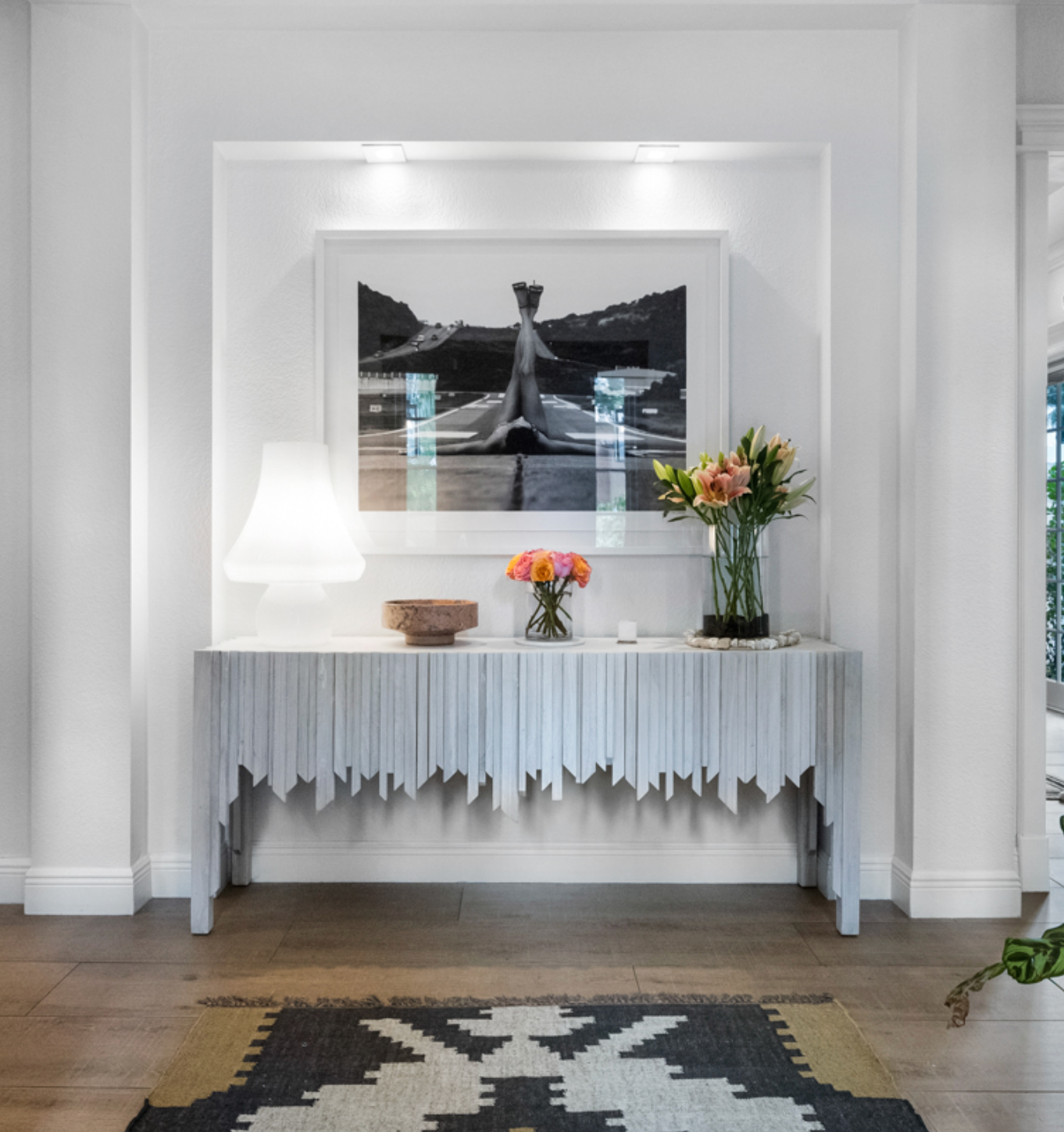 Console table with decorative items against a white wall